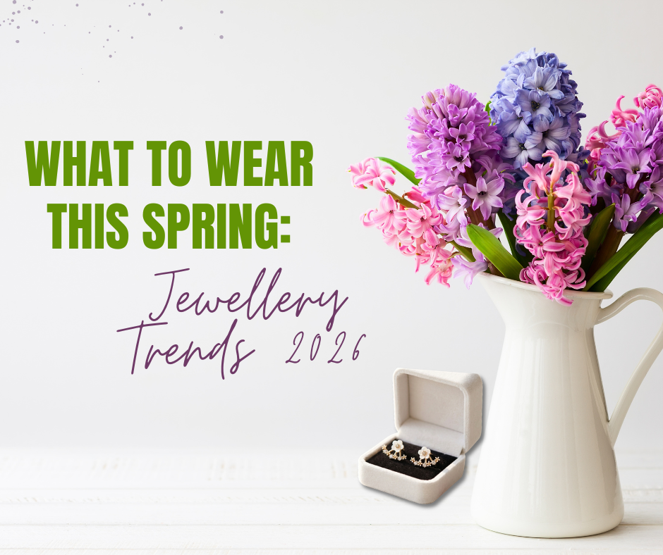 Spring jewellery trends 2026 — gold name necklace, floral bracelet, cherry blossom earrings and sunglasses flat lay on white marble with pink roses by Limitless Jewellery Canada.